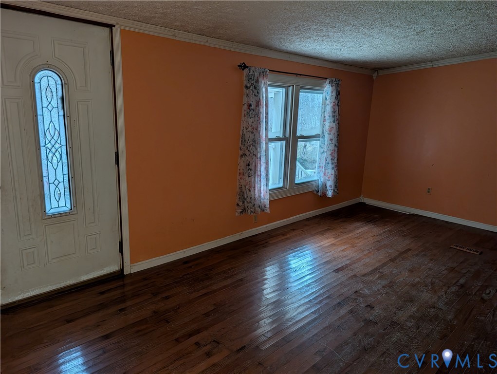 1149 Woodcrest Road Hurley, VA 24620 - Photo 5 of 32 an empty room with wooden floor and windows