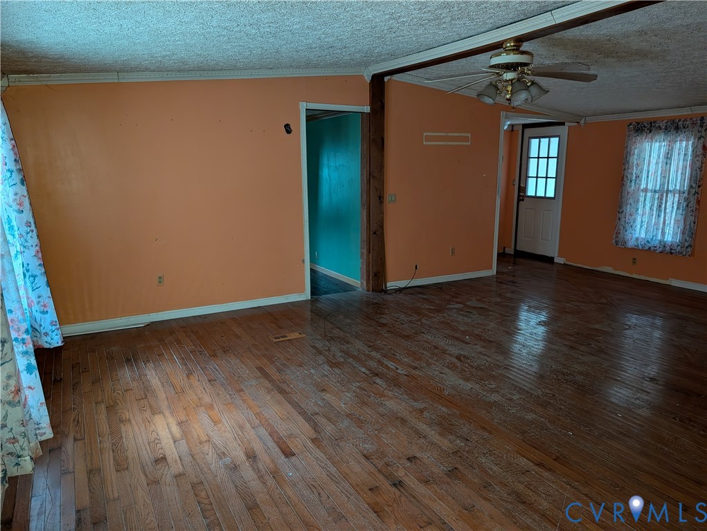 1149 Woodcrest Road Hurley, VA 24620 - Photo 6 of 32 an empty room with wooden floor and windows