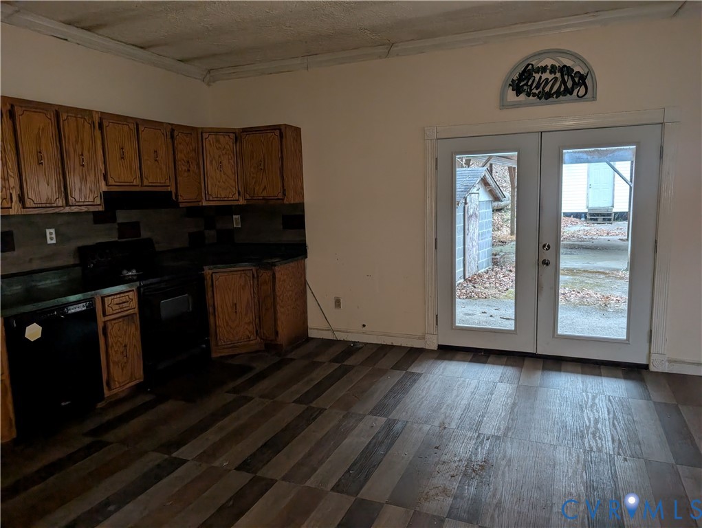 1149 Woodcrest Road Hurley, VA 24620 - Photo 9 of 32 a view of a kitchen with wooden floor and black appliances