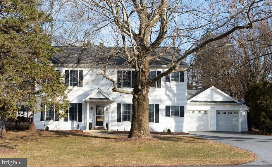 a front view of a house with a yard covered with snow