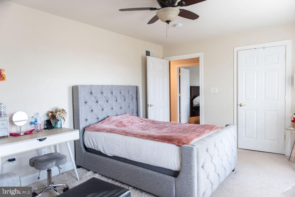 565 Sand Hill Road Hershey, PA 17033 - Photo 18 of 27 a bedroom with a bed and a chandelier