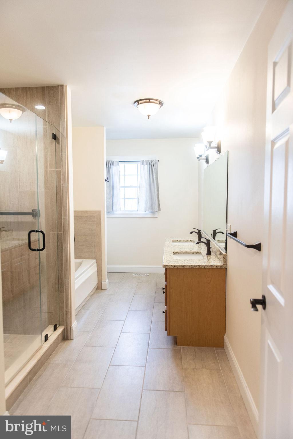 565 Sand Hill Road Hershey, PA 17033 - Photo 19 of 27 a view of a bathroom with a tub shower and sink