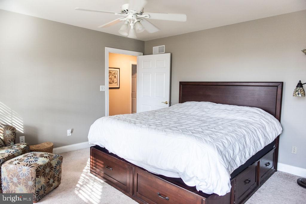 565 Sand Hill Road Hershey, PA 17033 - Photo 21 of 27 a bedroom with a large bed and a chandelier
