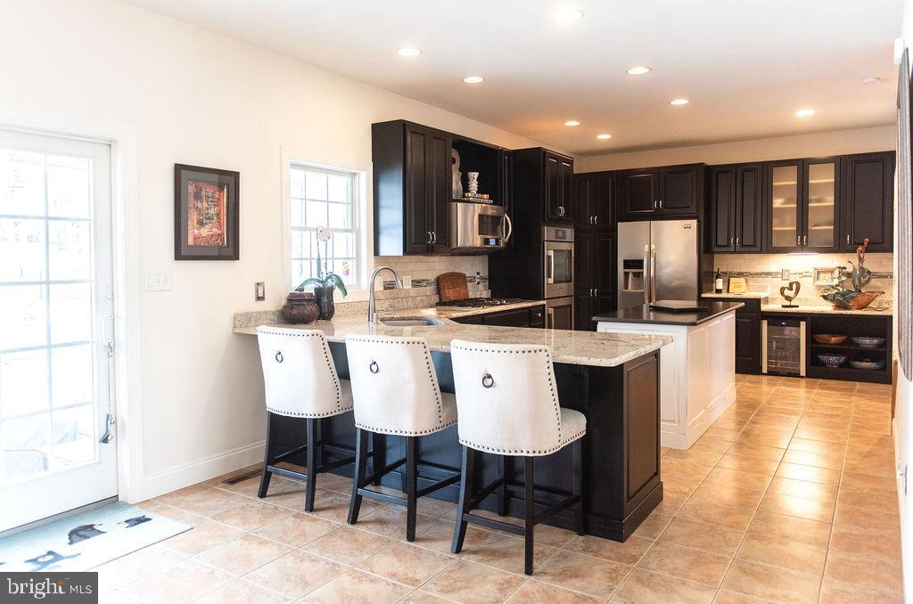 565 Sand Hill Road Hershey, PA 17033 - Photo 4 of 27 a large kitchen with a table and chairs