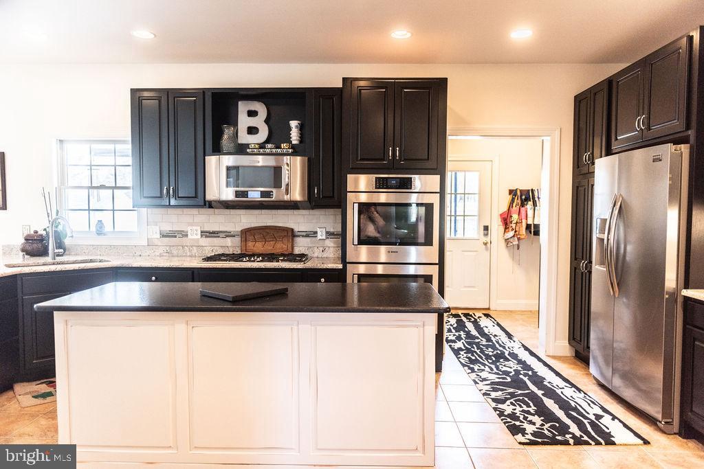 565 Sand Hill Road Hershey, PA 17033 - Photo 7 of 27 a kitchen with granite countertop a refrigerator and a sink