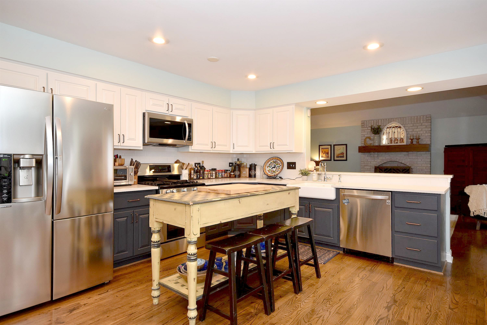 533 Lavina Drive Bolingbrook, IL 60440 - Photo 3 of 44 a kitchen with a sink a microwave a refrigerator and white cabinets