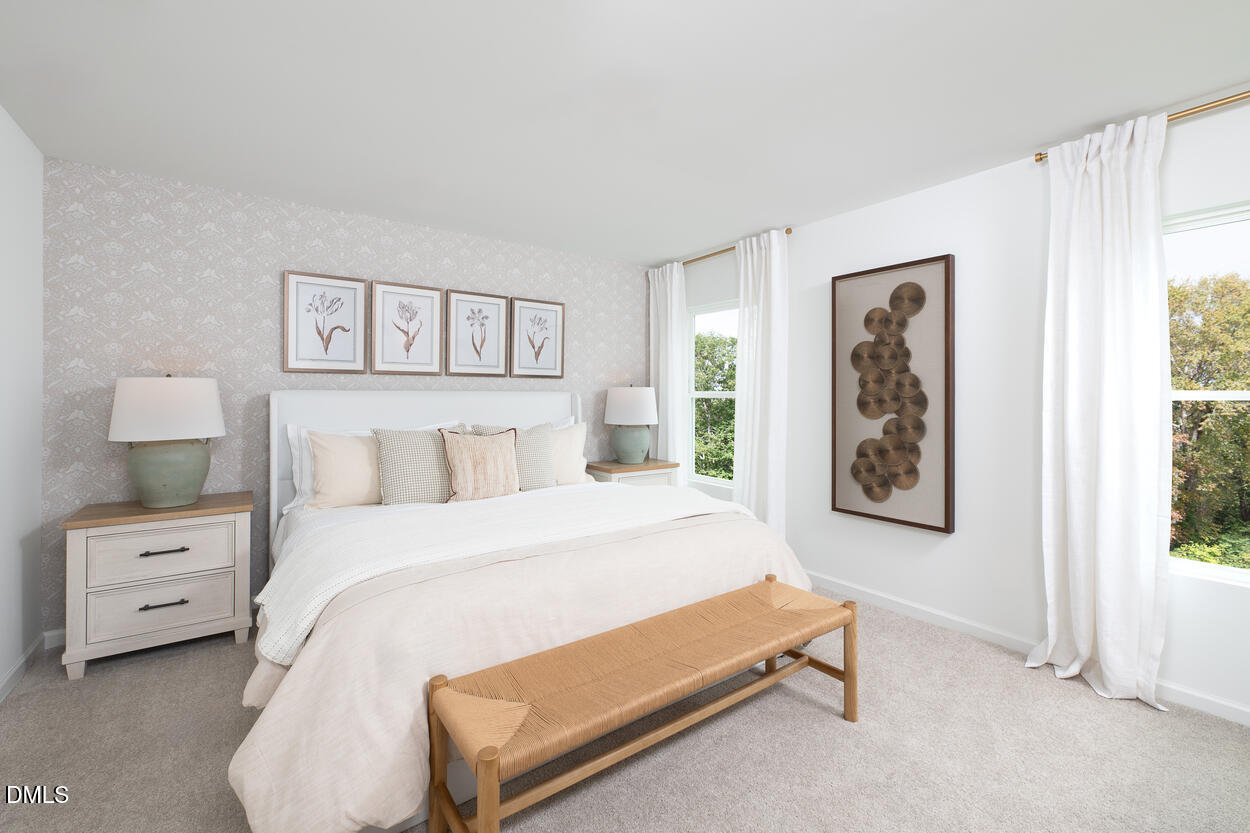 1511 Mirth Court Rolesville, NC 27571 - Photo 14 of 30 a bedroom with a bed and a painting on the wall