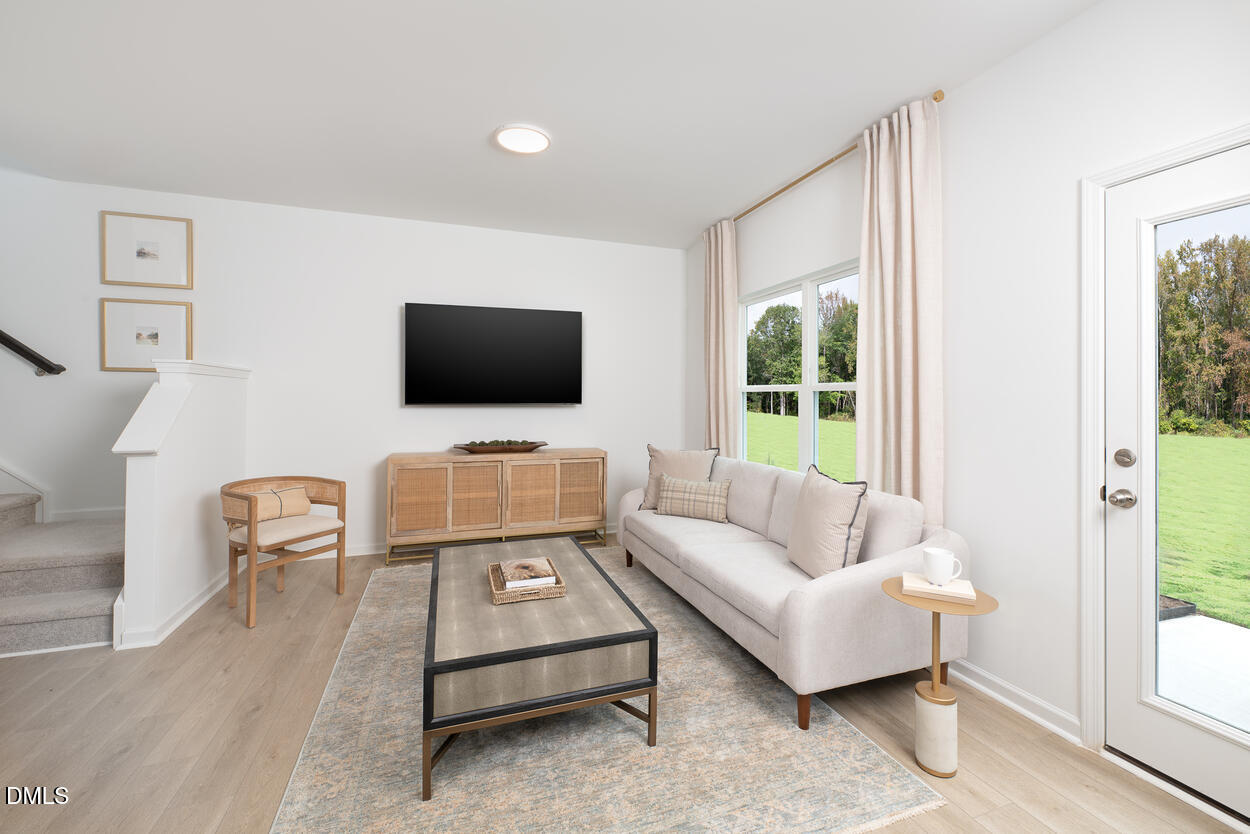 1511 Mirth Court Rolesville, NC 27571 - Photo 8 of 30 a living room with furniture and a flat screen tv