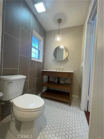 a bathroom with a toilet a sink and mirror
