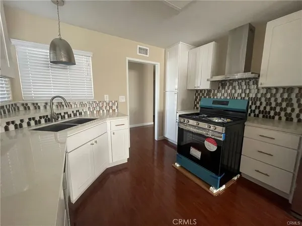 a kitchen with a stove and a microwave