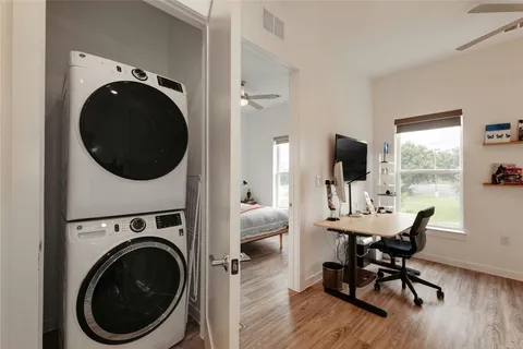 a view of a living room with furniture and a flat screen tv