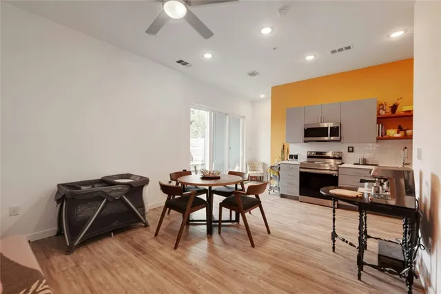 a view of a dining room with furniture and wooden floor