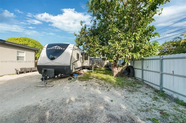 an aerial view of a house with a yard and plants