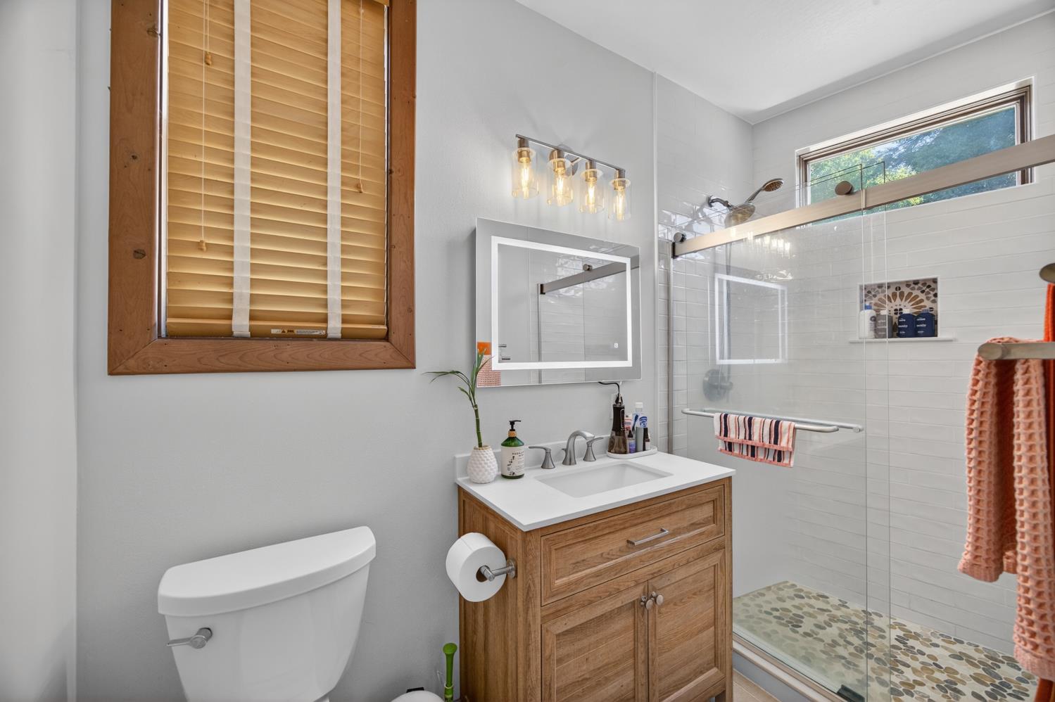 3940 Bannister Road Fair Oaks, CA 95628 - Photo 22 of 84 a bathroom with a granite countertop toilet sink and mirror