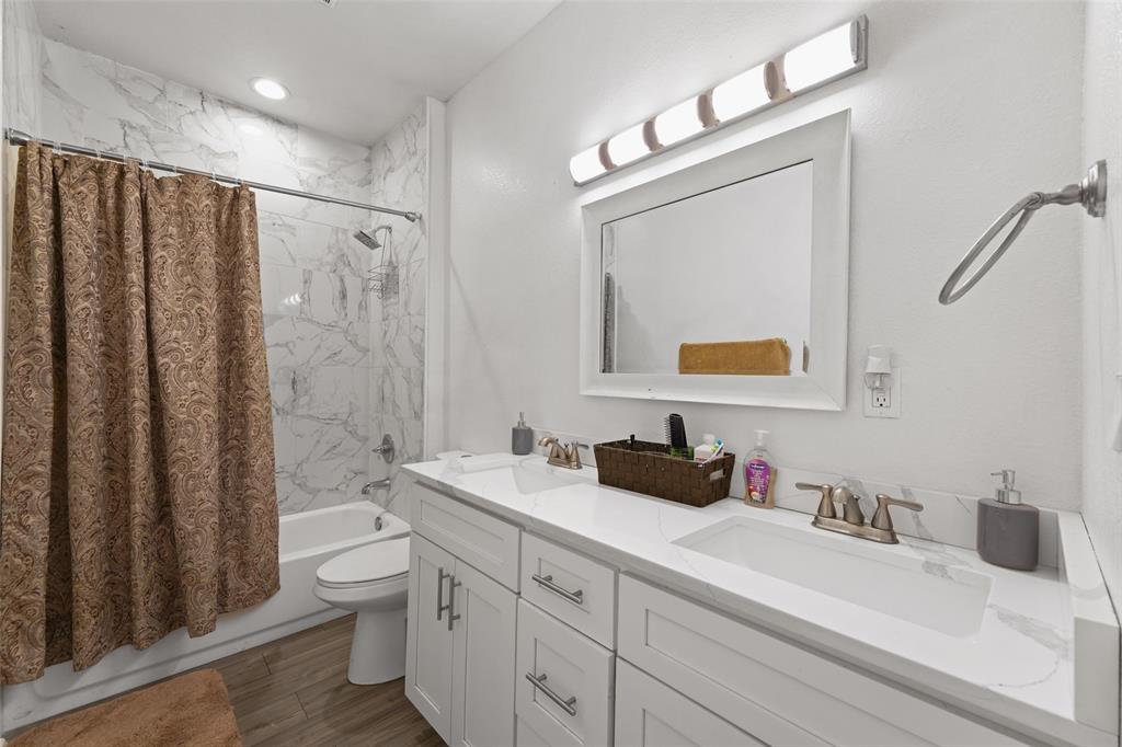 0 Ewing Road Ferris, TX 75125 - Photo 9 of 29 Bathroom featuring a dual-sink vanity with white cabinetry, a light-colored countertop, and a white framed mirror