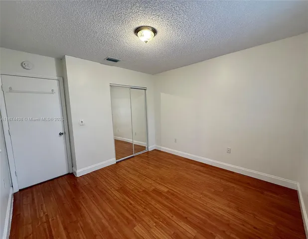 a view of a kitchen with microwave and cabinets
