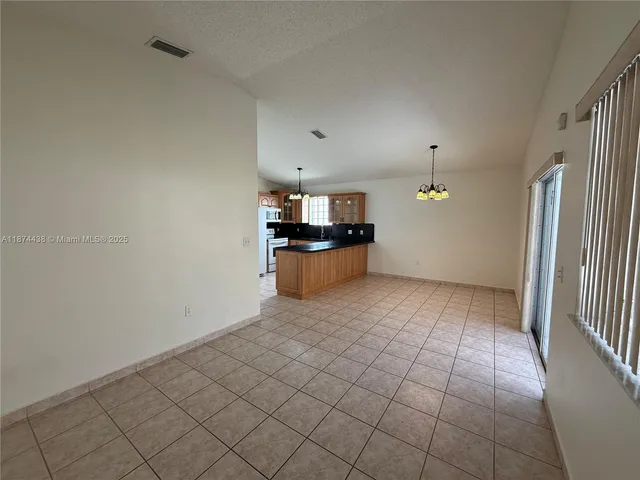 a kitchen with refrigerator and window