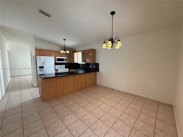 a view of a kitchen with microwave and cabinets