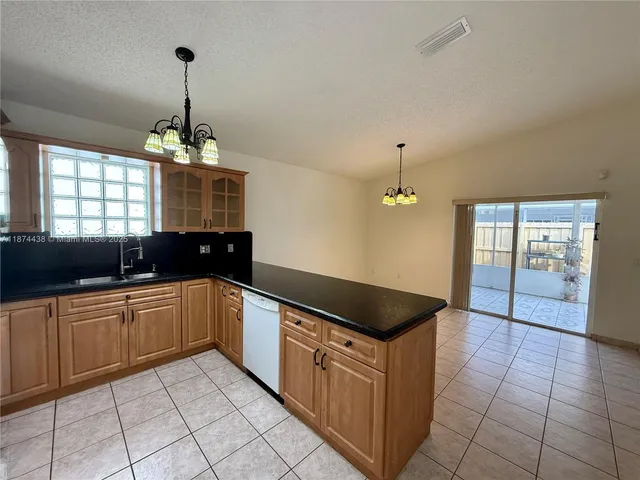 a kitchen with a cabinets and chandelier