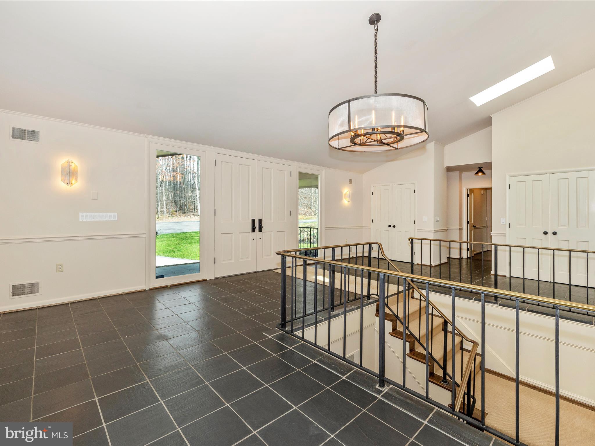 7702 Dance Hall Road Frederick, MD 21701 - Photo 11 of 66 a view of a room with wooden floor windows and a chandelier