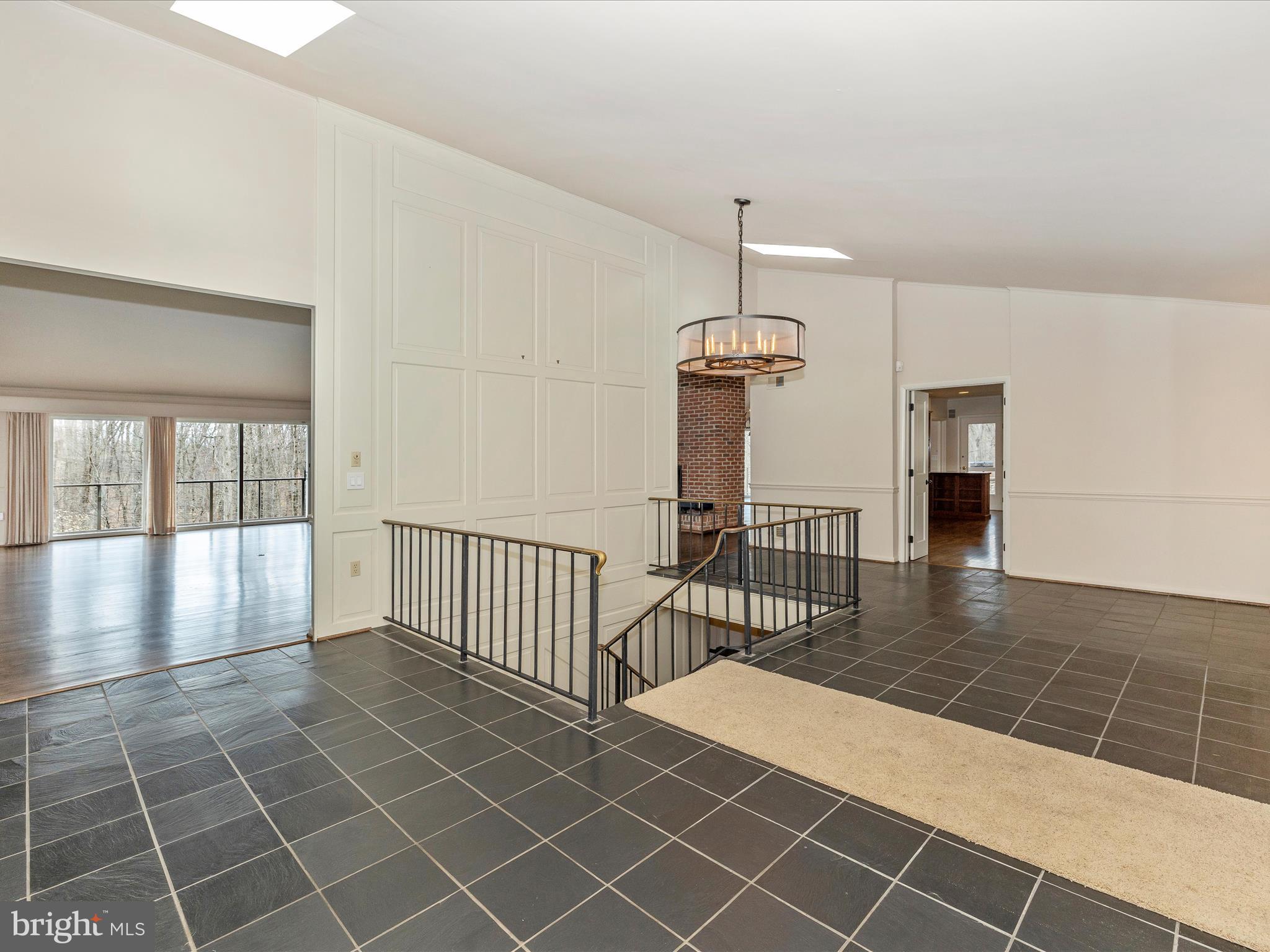 7702 Dance Hall Road Frederick, MD 21701 - Photo 12 of 66 an empty room with wooden floor fireplace and windows
