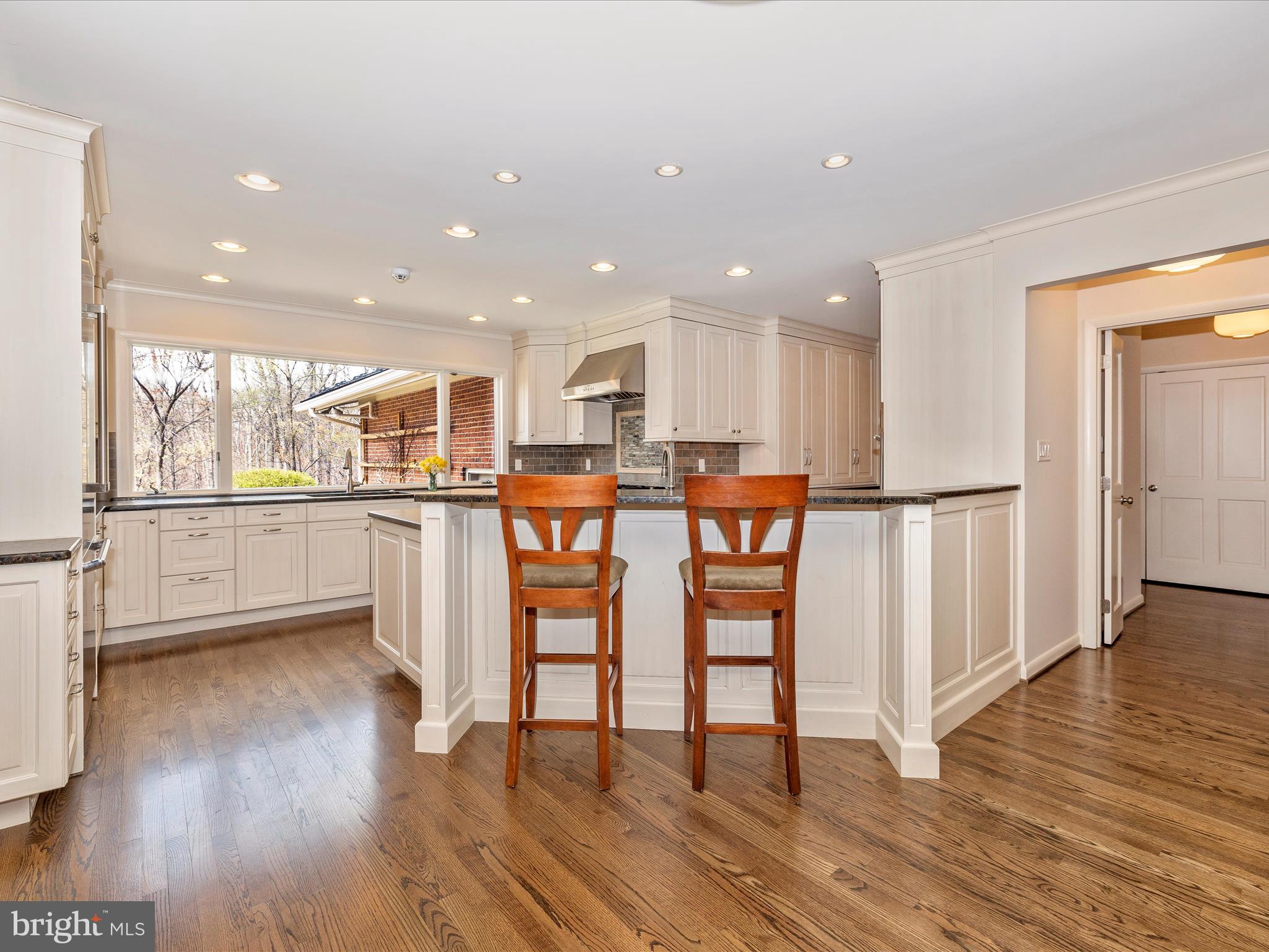 7702 Dance Hall Road Frederick, MD 21701 - Photo 20 of 66 a kitchen with stainless steel appliances kitchen island granite countertop wooden floors and cabinets