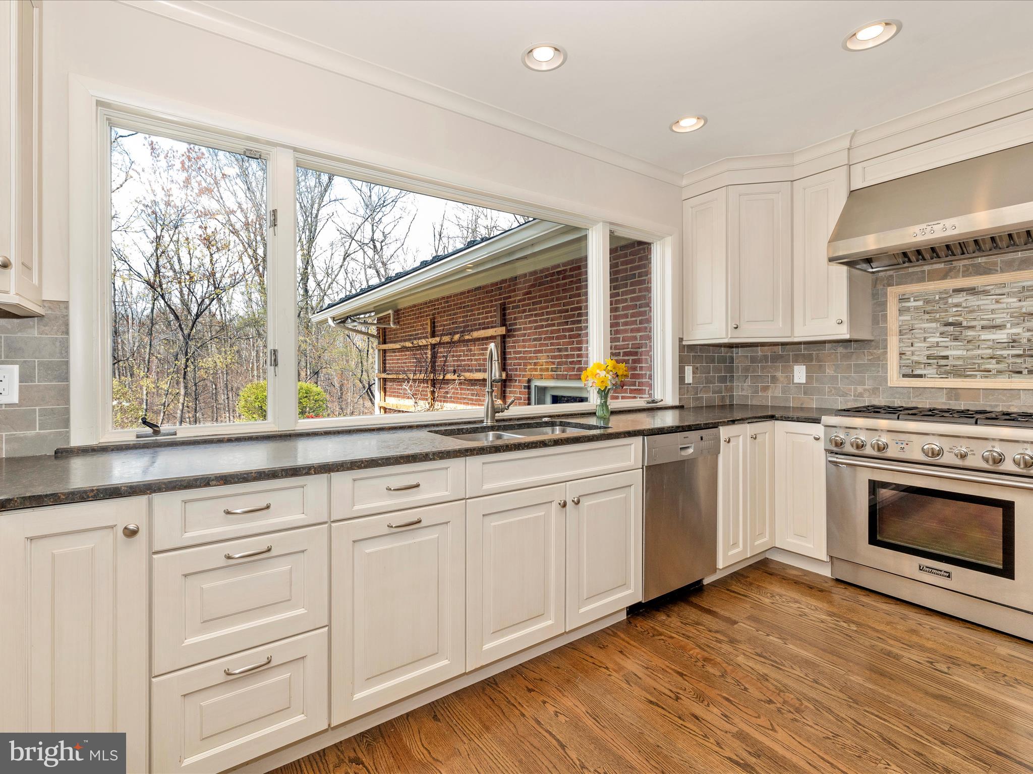 7702 Dance Hall Road Frederick, MD 21701 - Photo 22 of 66 a kitchen with granite countertop white cabinets and white appliances
