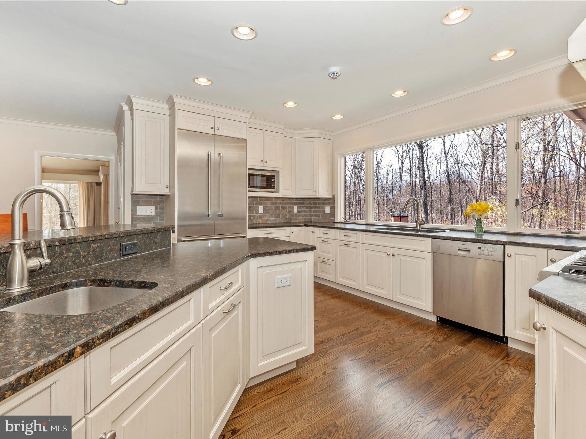 7702 Dance Hall Road Frederick, MD 21701 - Photo 25 of 66 a kitchen with stainless steel appliances granite countertop a sink a stove and cabinets