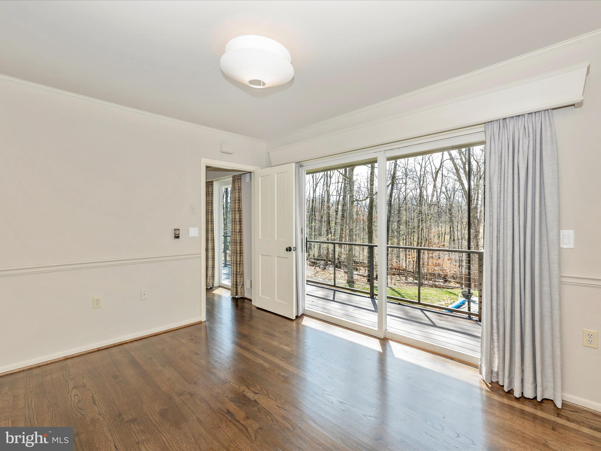 7702 Dance Hall Road Frederick, MD 21701 - Photo 33 of 66 a view of an empty room with wooden floor and a window