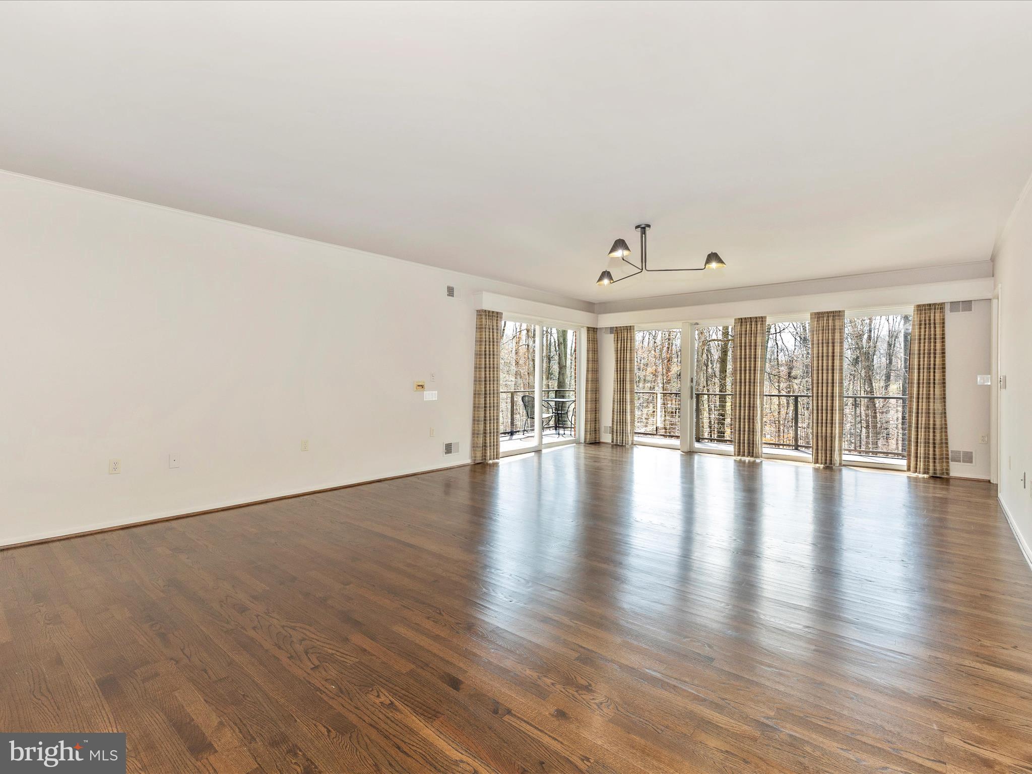 7702 Dance Hall Road Frederick, MD 21701 - Photo 35 of 66 a view of an empty room with wooden floor and a window