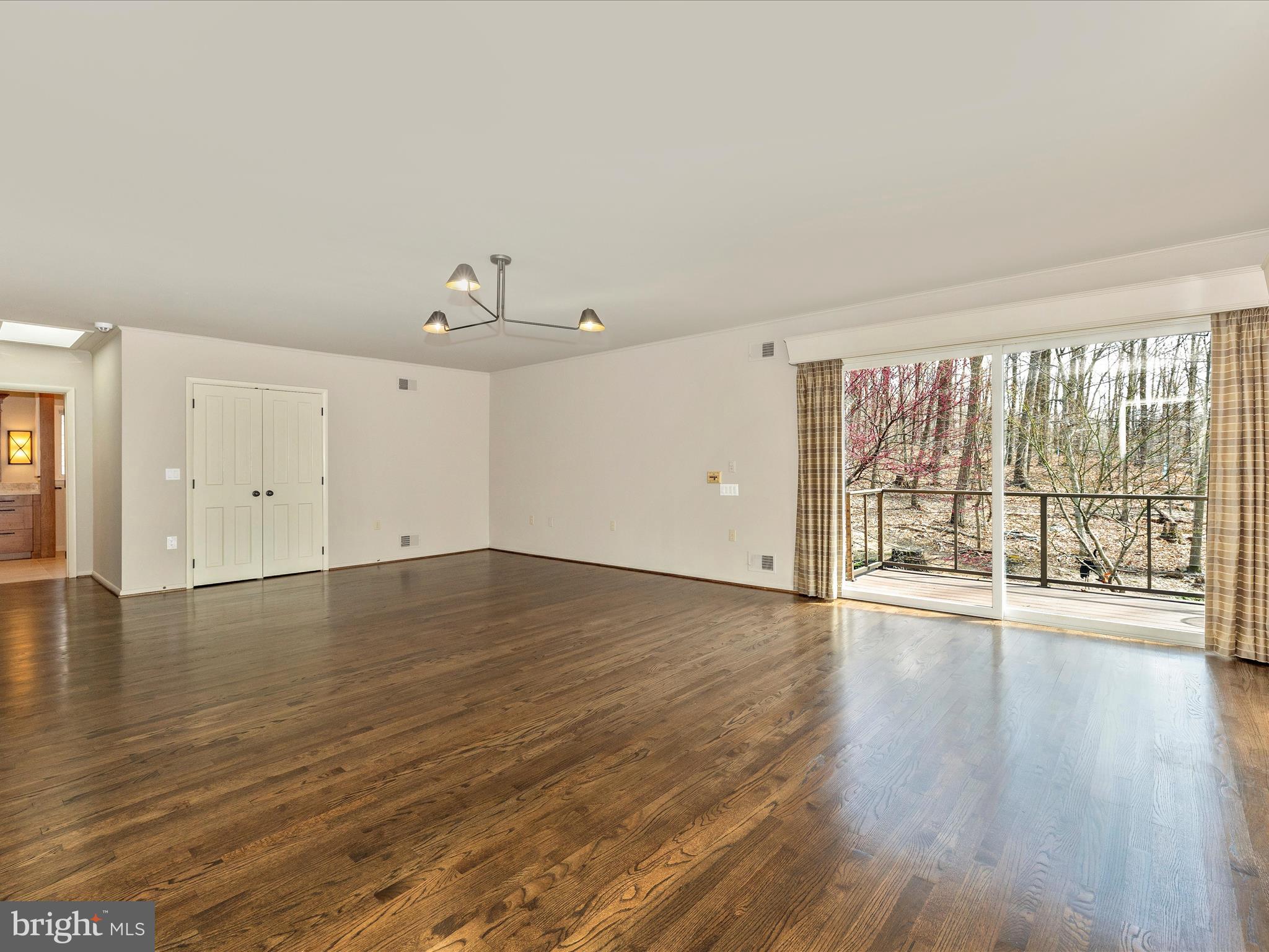 7702 Dance Hall Road Frederick, MD 21701 - Photo 36 of 66 a view of an empty room with wooden floor and a window