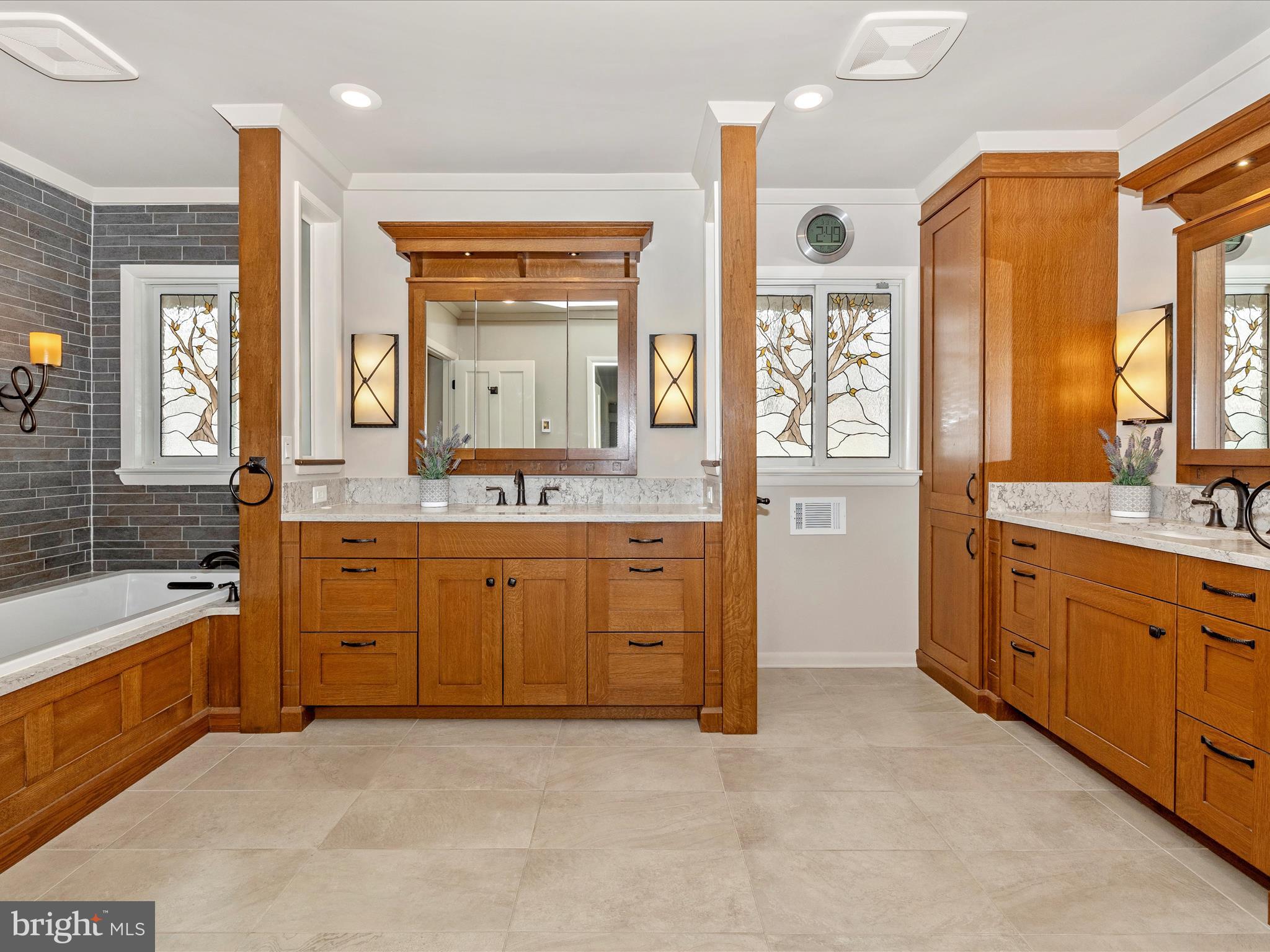 7702 Dance Hall Road Frederick, MD 21701 - Photo 38 of 66 a spacious bathroom with a granite countertop sink mirror and a bathtub