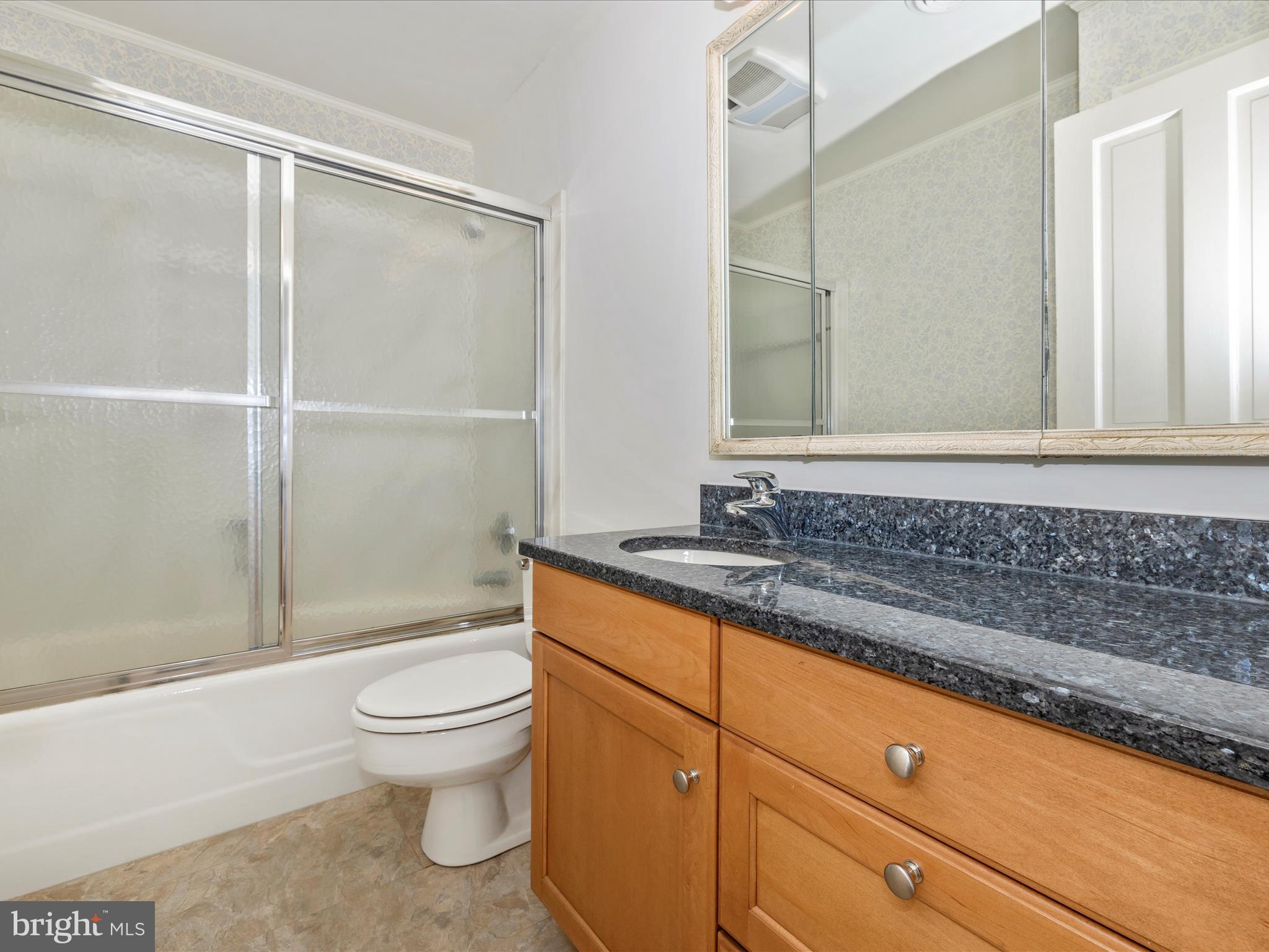 7702 Dance Hall Road Frederick, MD 21701 - Photo 54 of 66 a bathroom with a granite countertop sink toilet and shower