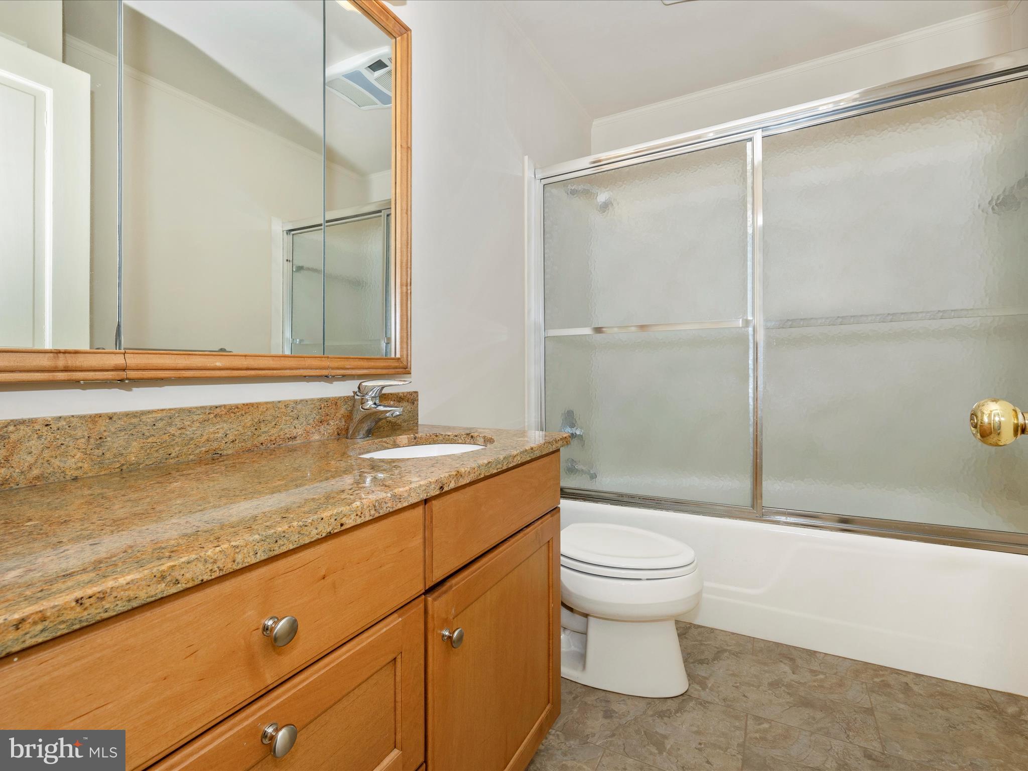 7702 Dance Hall Road Frederick, MD 21701 - Photo 56 of 66 a bathroom with a granite countertop sink a toilet and shower