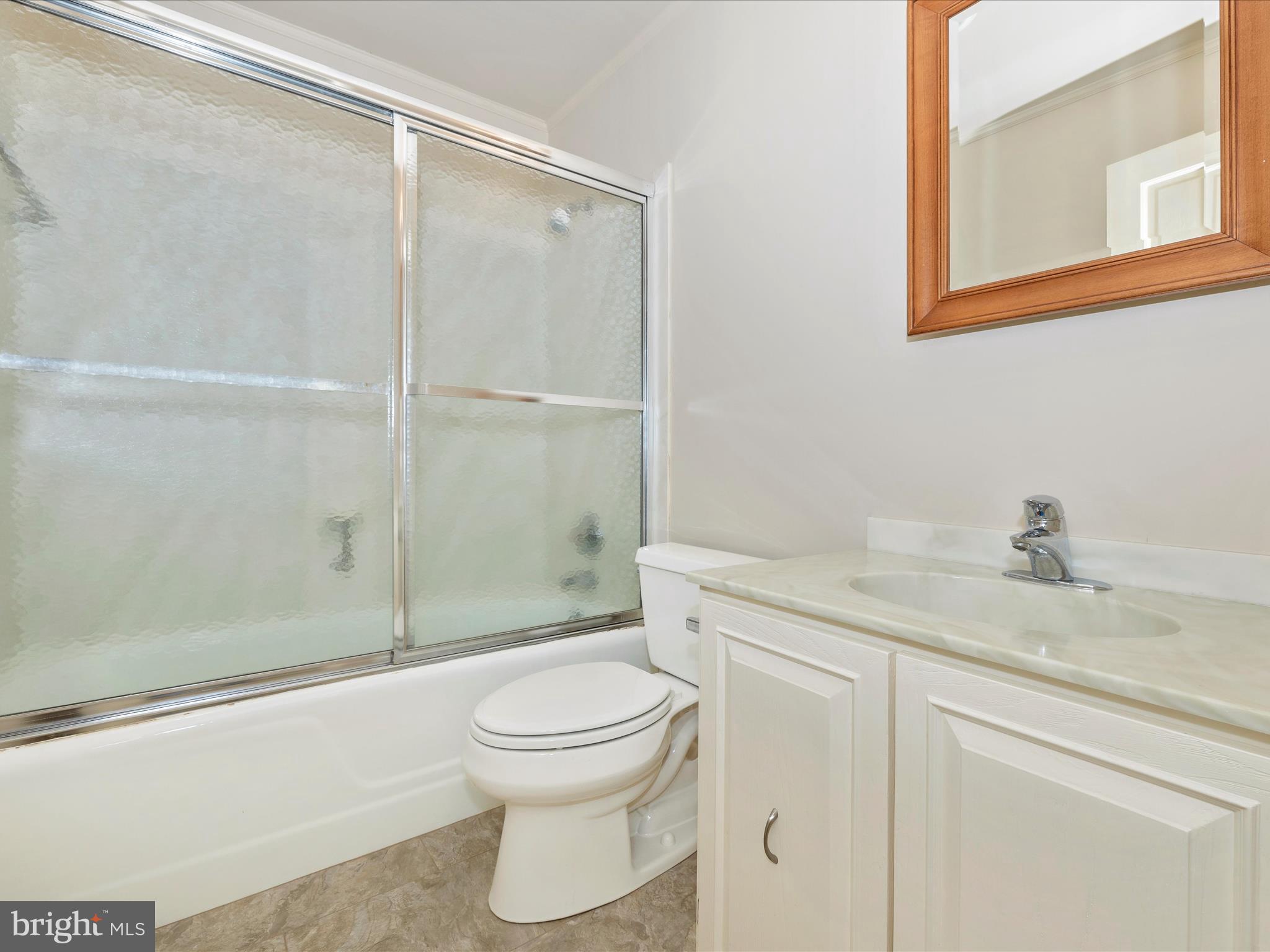 7702 Dance Hall Road Frederick, MD 21701 - Photo 58 of 66 a bathroom with a granite countertop sink toilet and shower