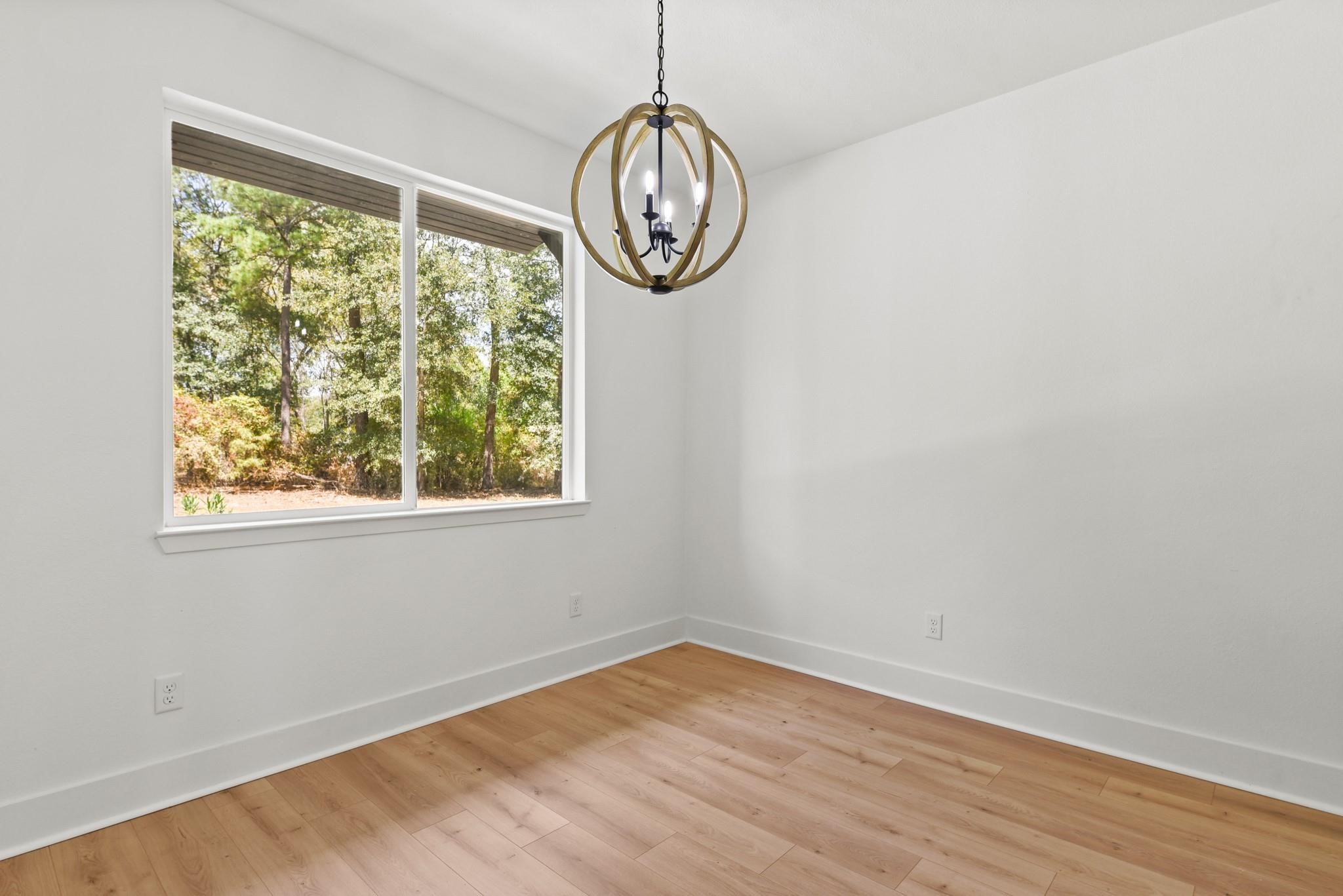 17068 Lively Road Waller, TX 77484 - Photo 12 of 29 a view of empty room with wooden floor and fan