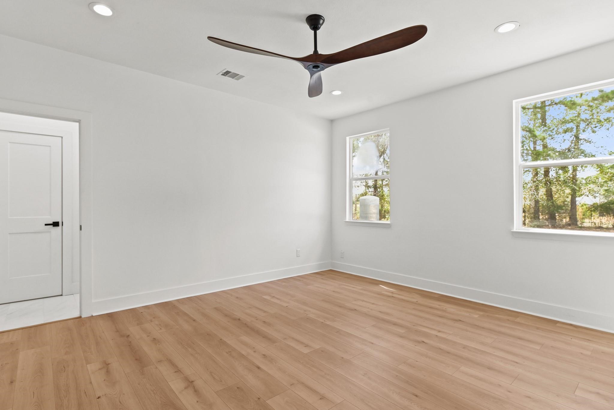 17068 Lively Road Waller, TX 77484 - Photo 15 of 29 a view of empty room with wooden floor and fan