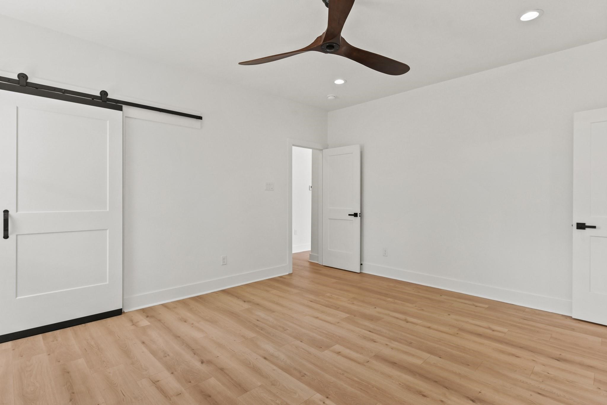 17068 Lively Road Waller, TX 77484 - Photo 16 of 29 a view of an empty room with wooden floor