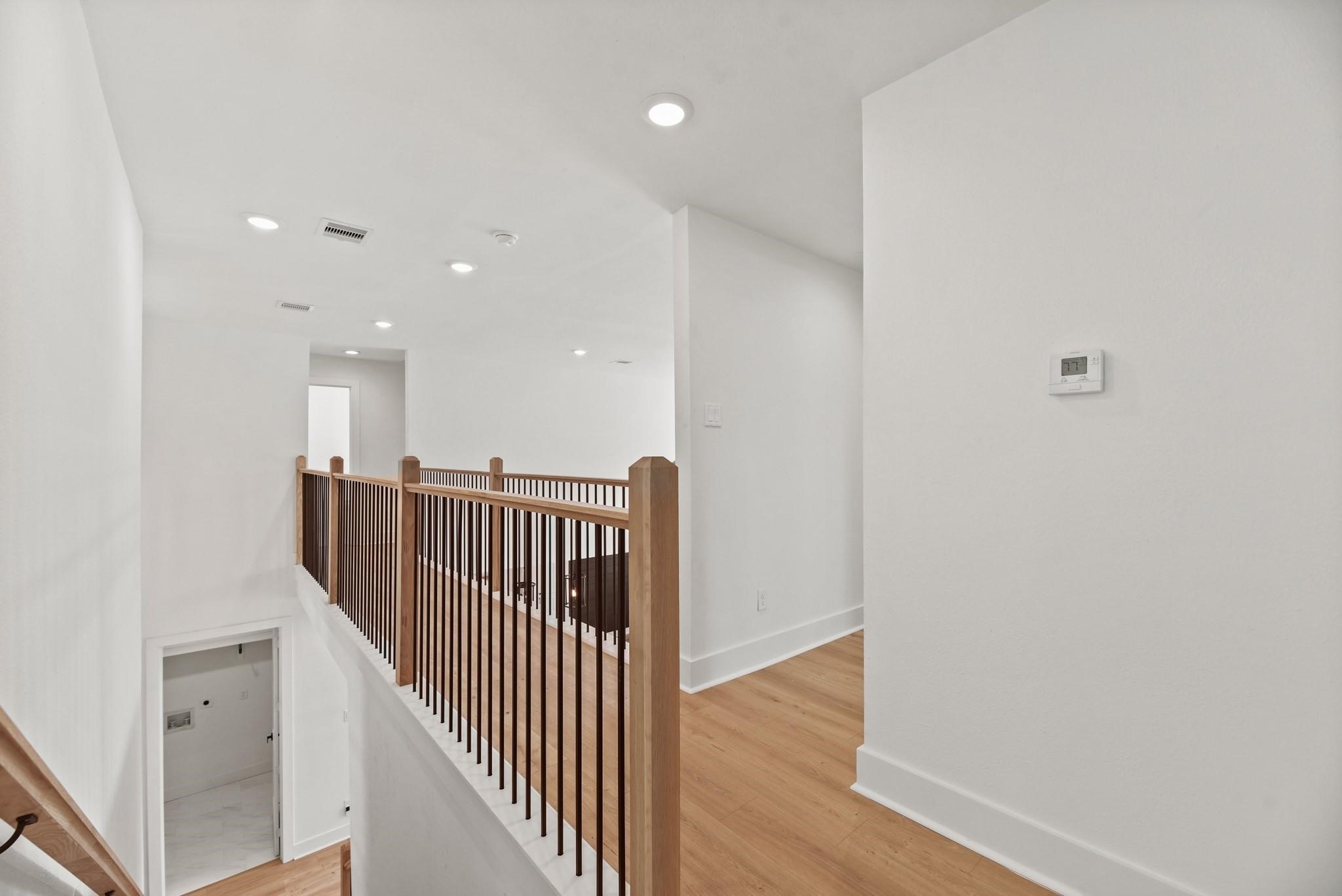 17068 Lively Road Waller, TX 77484 - Photo 20 of 29 a view of a hallway with wooden floor and staircase