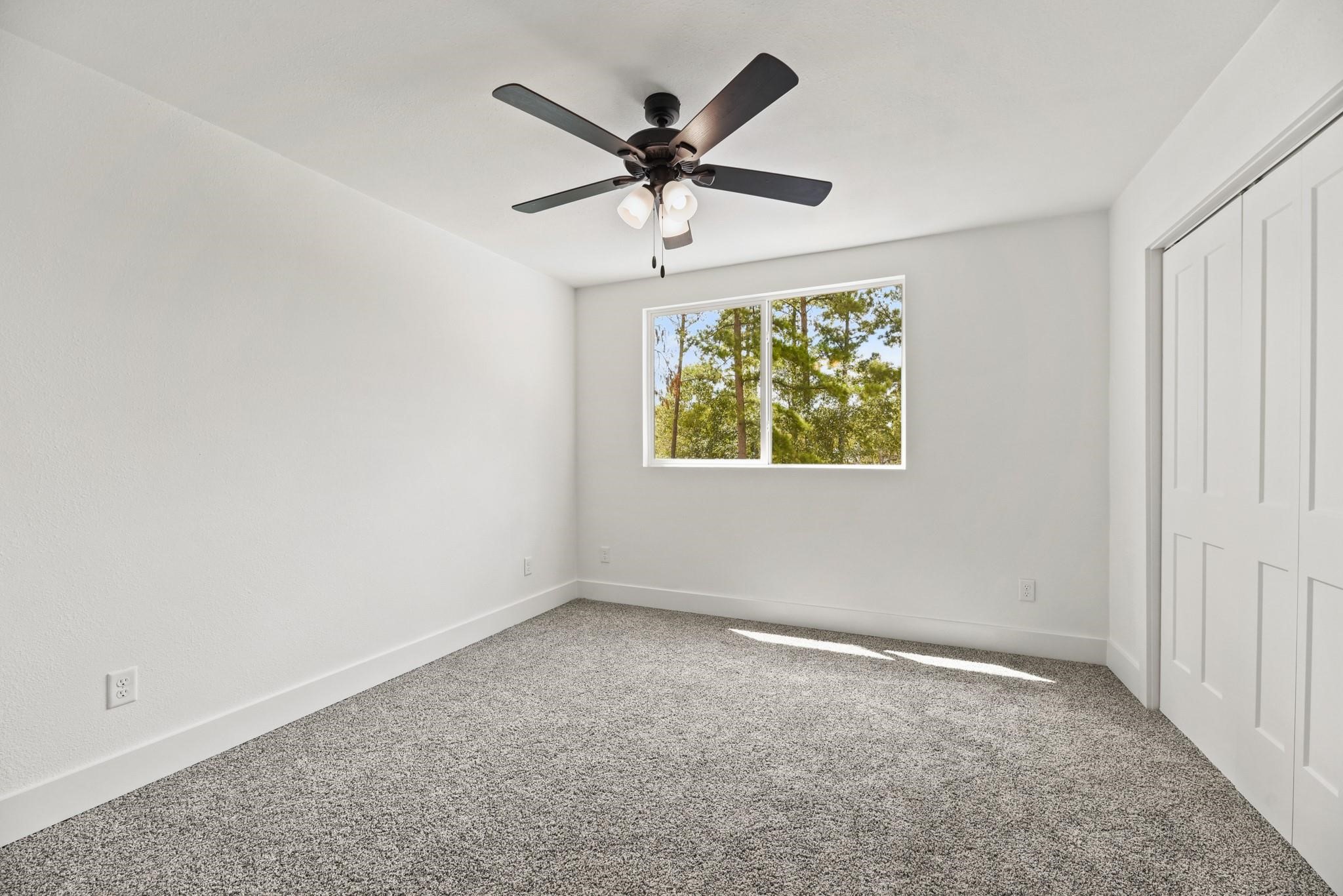 17068 Lively Road Waller, TX 77484 - Photo 21 of 29 an empty room with windows and ceiling fan
