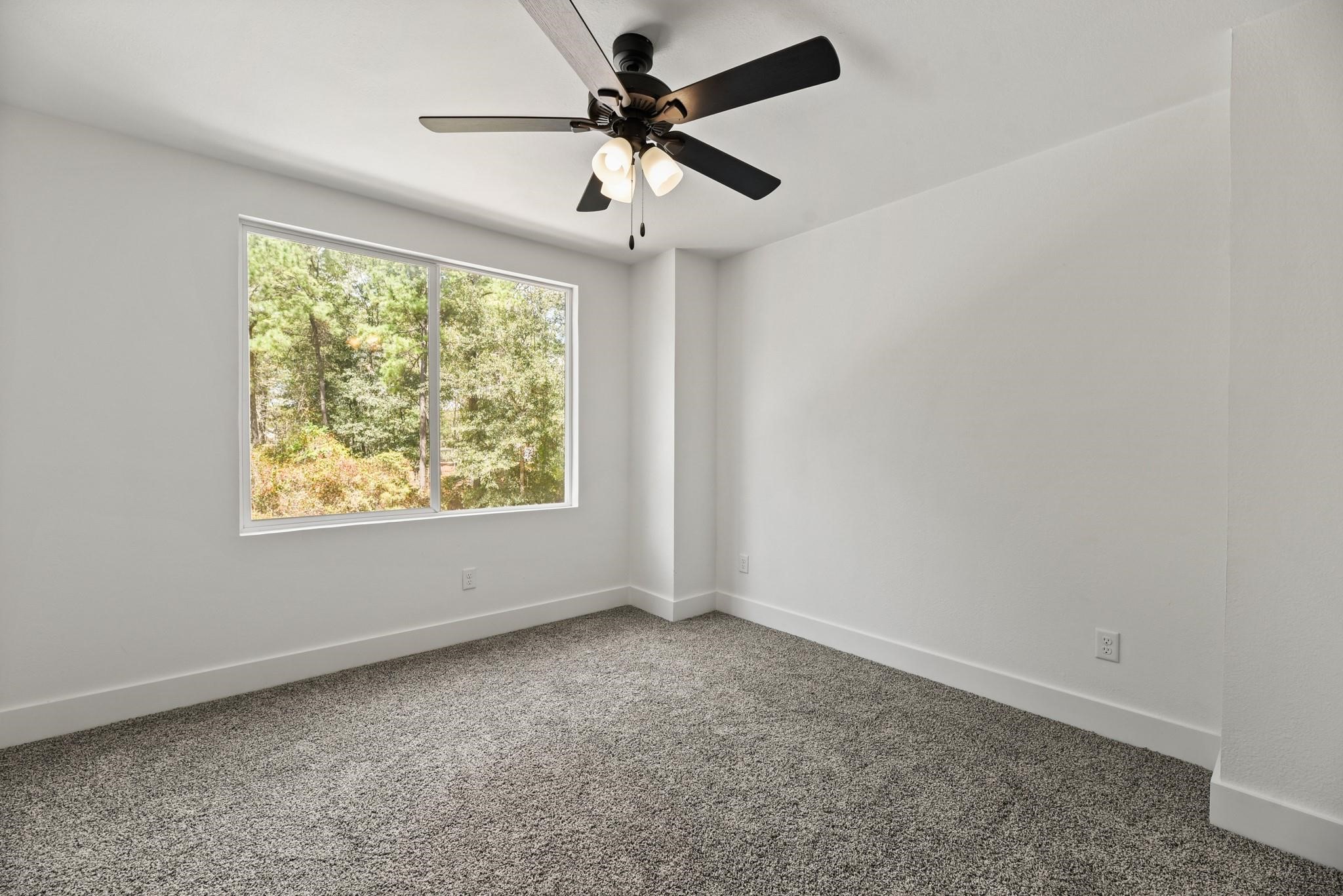 17068 Lively Road Waller, TX 77484 - Photo 24 of 29 an empty room with a window and a fan