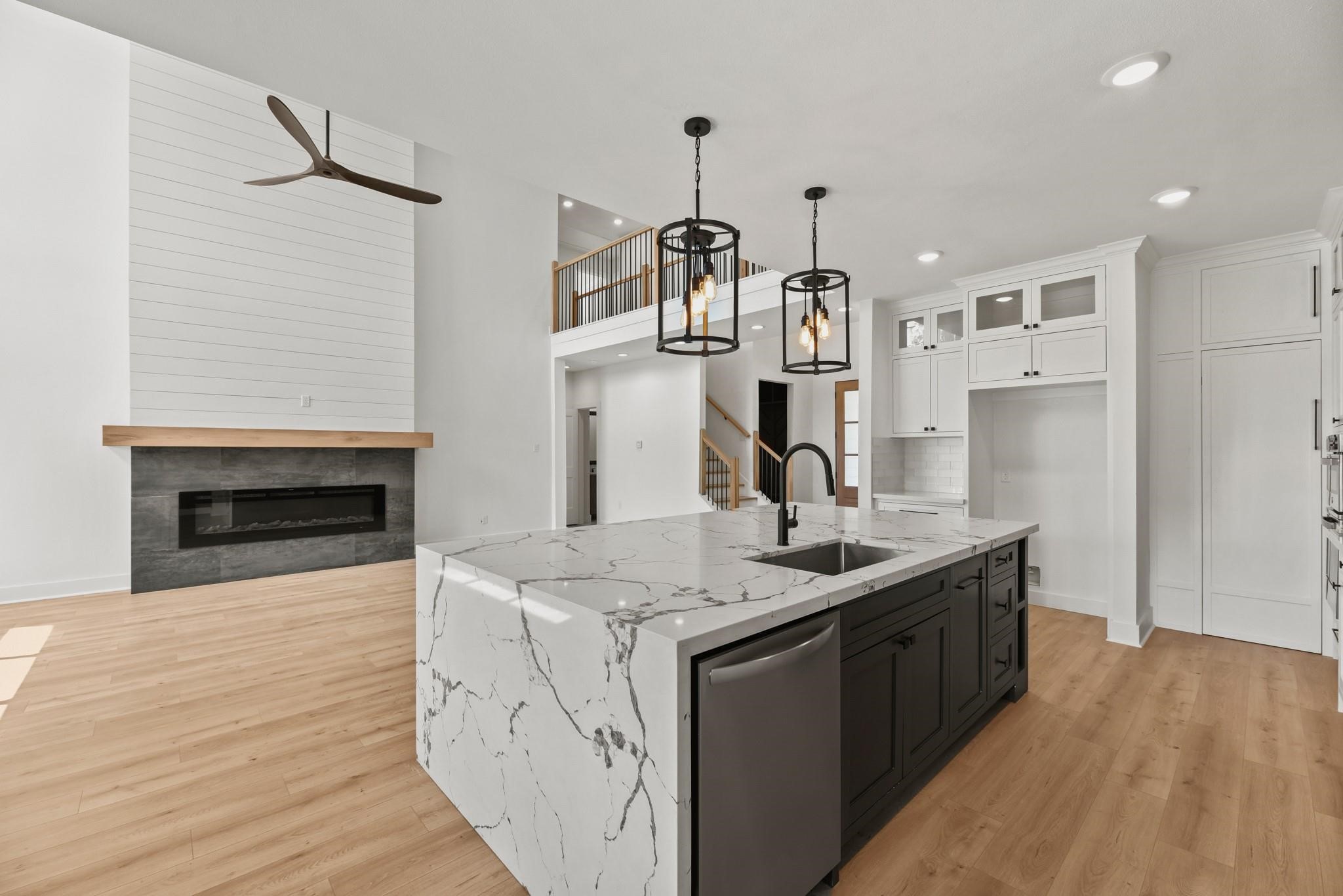 17068 Lively Road Waller, TX 77484 - Photo 7 of 29 a kitchen with stainless steel appliances granite countertop a sink cabinets and wooden floor