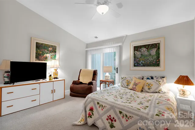 a bedroom with furniture and a flat screen tv