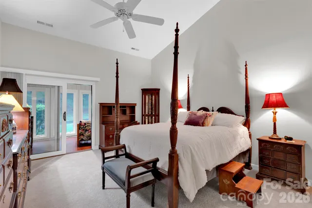 a bedroom with furniture and a chandelier