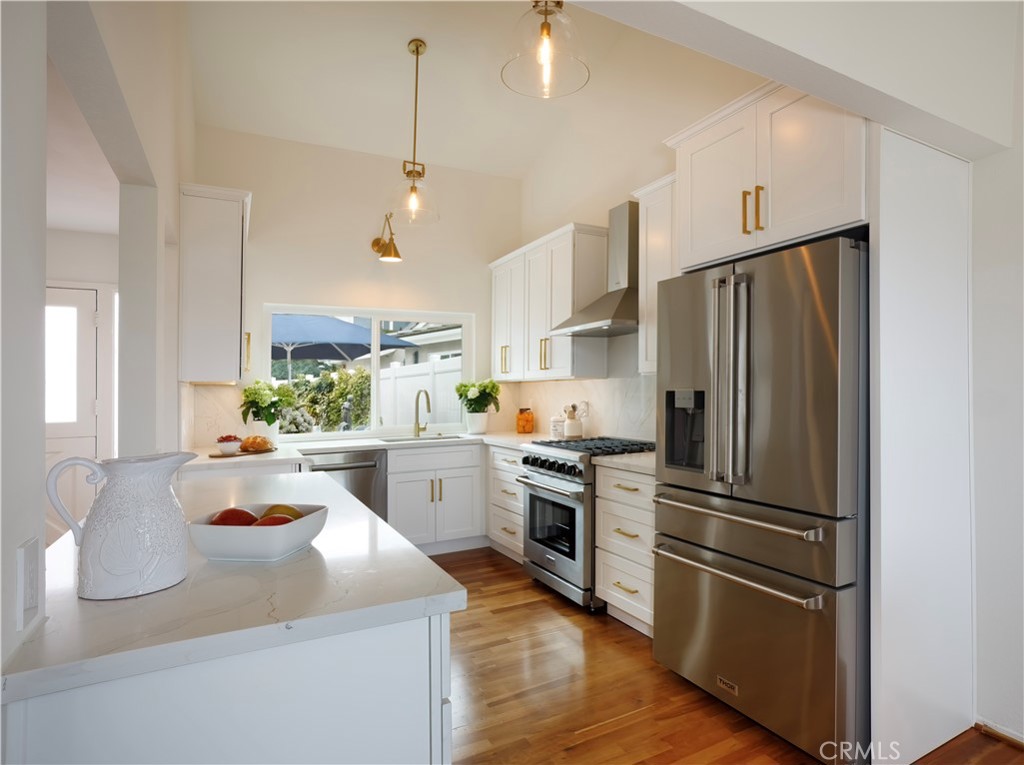 33525 Sextant Dana Point, CA 92629 - Photo 12 of 51 a kitchen with refrigerator cabinets and wooden floor