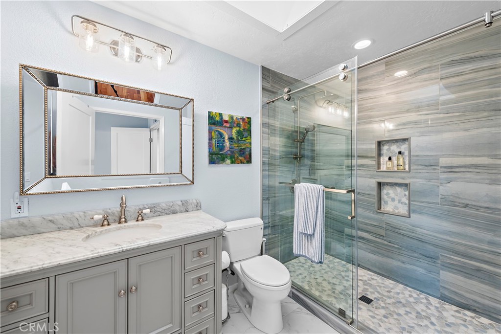 33525 Sextant Dana Point, CA 92629 - Photo 21 of 51 a bathroom with a granite countertop sink toilet and shower