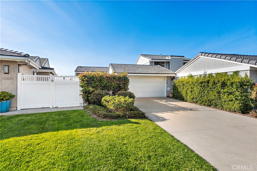33525 Sextant Dana Point, CA 92629 - Photo 35 of 51 a front view of a house with a yard and garage