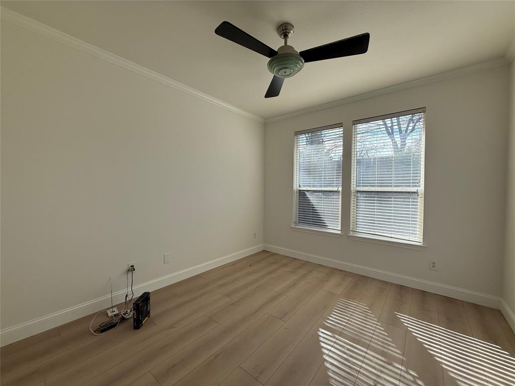 2254 Ash Grove Way Dallas, TX 75228 - Photo 12 of 23 an empty room with a window and wooden floor