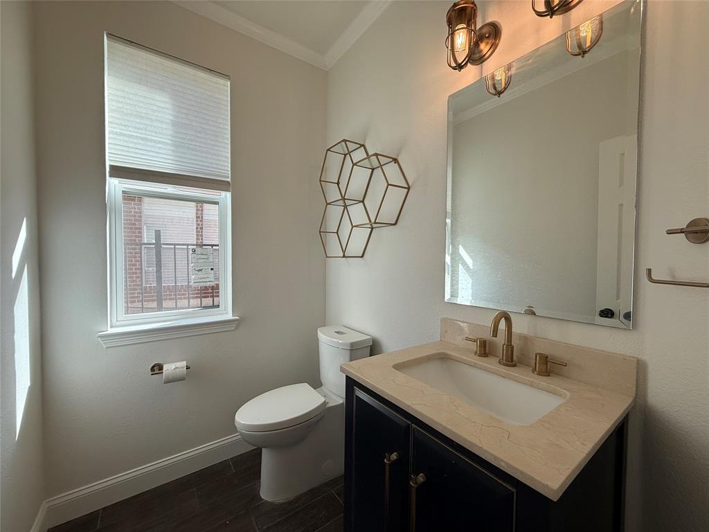 2254 Ash Grove Way Dallas, TX 75228 - Photo 16 of 23 a bathroom with a granite countertop sink toilet and a mirror