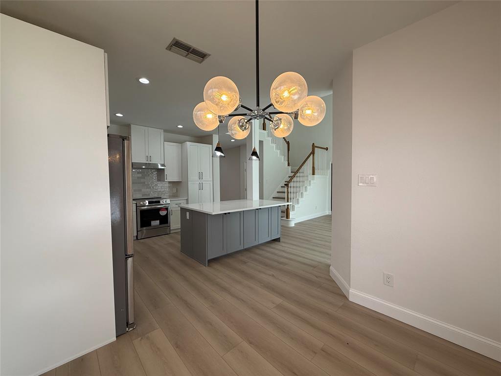 2254 Ash Grove Way Dallas, TX 75228 - Photo 18 of 23 a view of a living room with wooden floor and ceiling fan